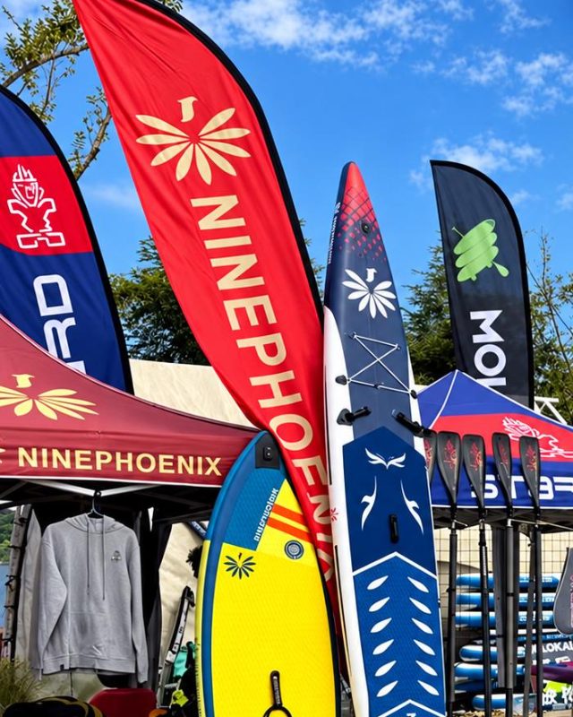 Custom Ninephoenix feather flags at an outdoor event