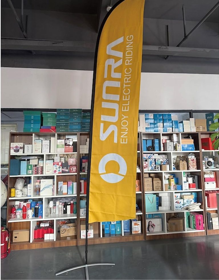 Yellow SUNRA feather flag inside a showroom