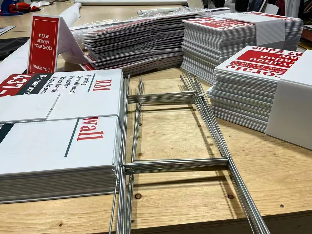 Stack of printed yard signs with H-stakes